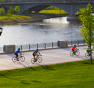 four bikers along the scioto river in downtown columbus