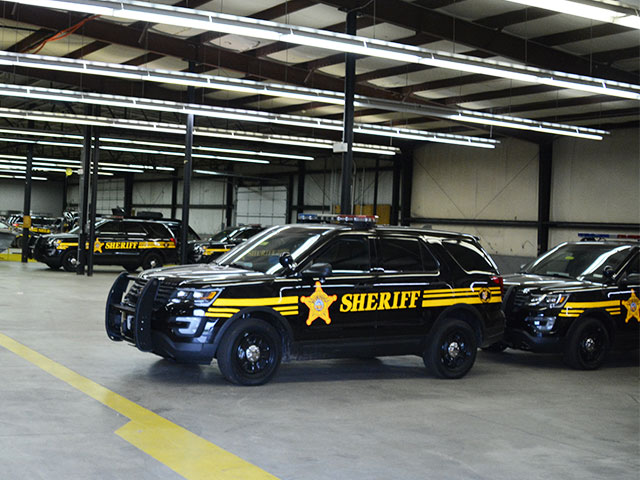Sherif's fleet of SUVs in a garage