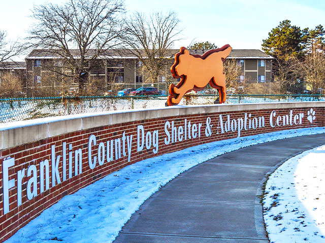 retaining brick wall with adoption shelter sign